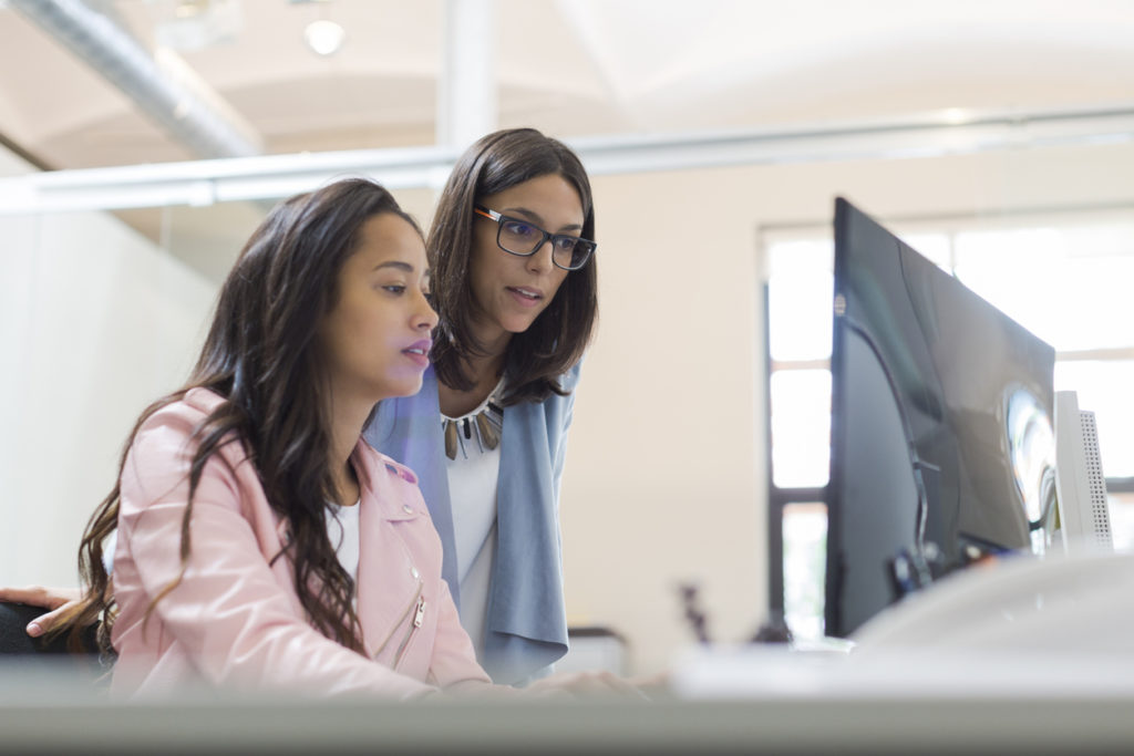 Two people in front of the computer during a career coaching session